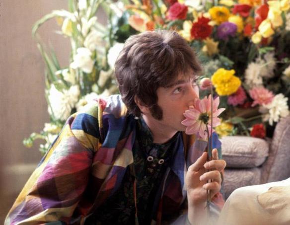 John Lennon sniffs a flower while visiting Maharishi Mahesh Yogi, 1967. (Henry Grossman)